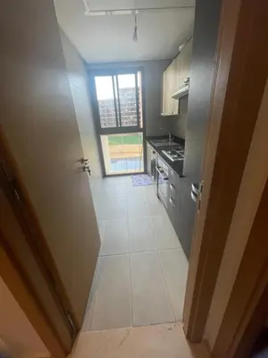 a view of a kitchen with a door open at appartement 5min a pied du stade in Rabat