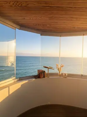 a view of the ocean from a room with a large window at Epic Oceanfront Flat - 360 Sea View in Casablanca
