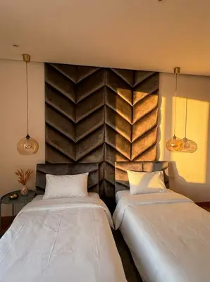 two beds in a room with a wall at Epic Oceanfront Flat - 360 Sea View in Casablanca
