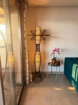 a floor lamp in a room with a table at Epic Oceanfront Flat - 360 Sea View in Casablanca