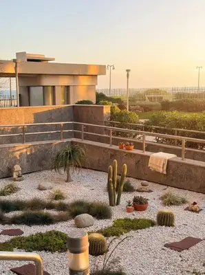 a house with cacti and plants in front of it at Epic Oceanfront Flat - 360 Sea View in Casablanca