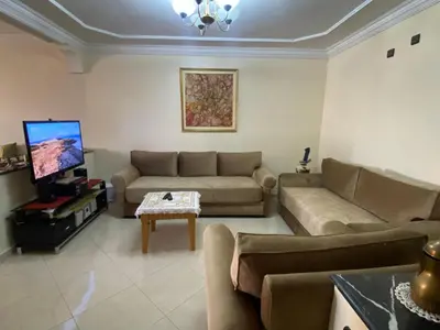 a living room with a couch and a tv at Palace, Appartement Rabat Agdal in Rabat