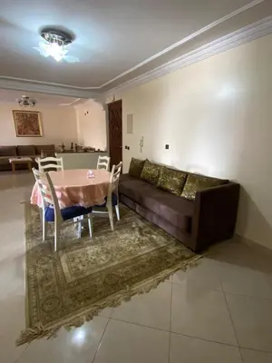 a living room with a couch and a table and chairs at Palace, Appartement Rabat Agdal in Rabat
