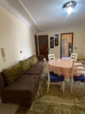 a living room with a couch and a table at Palace, Appartement Rabat Agdal in Rabat