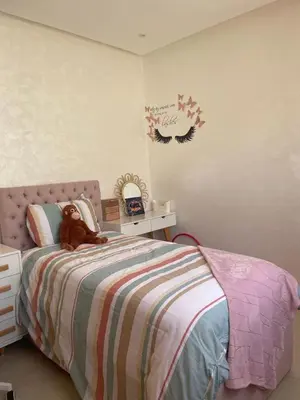 a teddy bear sitting on a bed in a bedroom at Beautiful beachfront villa in Dar Bouazza