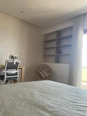 a bedroom with a bed and a desk and a chair at Beautiful beachfront villa in Dar Bouazza