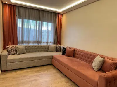 a couch in a living room with a window at Luxury SeaView Apartment 2 Minutes From Beachfront in Rabat