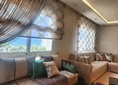 a living room with a couch and a large window at Luxury SeaView Apartment 2 Minutes From Beachfront in Rabat