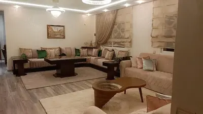 a living room with a couch and a table at Luxury SeaView Apartment 2 Minutes From Beachfront in Rabat