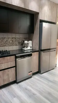 a kitchen with a refrigerator and a stove at Luxury SeaView Apartment 2 Minutes From Beachfront in Rabat
