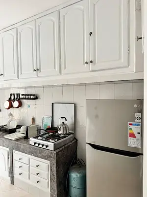 a kitchen with white cabinets and a white refrigerator at Luxury House in Rabat in Rabat