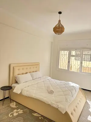 a white bedroom with a large bed and a window at Luxury House in Rabat in Rabat