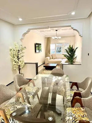 a living room with a glass table and chairs at Luxury House in Rabat in Rabat