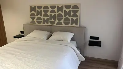 a white bed with two pillows in a bedroom at Casablanca Luxe studio in Casablanca