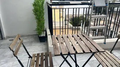 a wooden bench sitting next to a bird cage at Casablanca Luxe studio in Casablanca