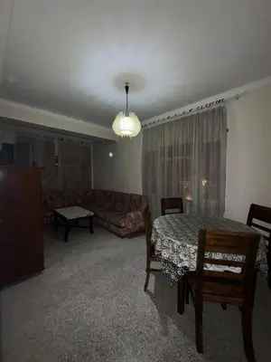 a living room with a table and a couch at House for rent in Agdal in Rabat
