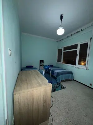 a bedroom with a bed and a dresser in it at House for rent in Agdal in Rabat