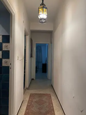 an empty hallway with a chandelier and a hallway leading to a room at House for rent in Agdal in Rabat