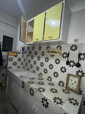 a kitchen with a white and blue tiled counter top at House for rent in Agdal in Rabat