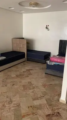 a room with two beds and a ceiling at Casablanca Happy Homestay in Casablanca