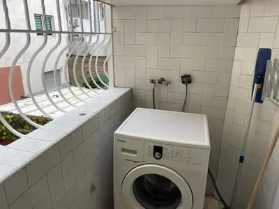 a washing machine in a bathroom with a window at Casablanca Happy Homestay in Casablanca