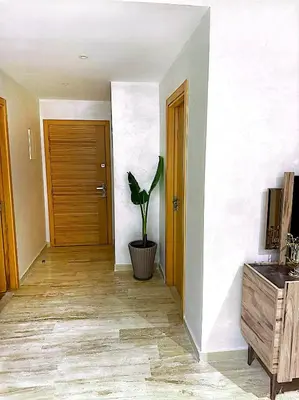 a hallway with a door and a potted plant at Host By Med in Casablanca
