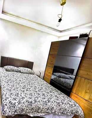 a bedroom with a bed and a large mirror at Host By Med in Casablanca