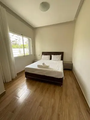 a bedroom with a bed and a wooden floor at Villa Prestige avec piscine in Tamaris