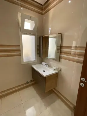 a bathroom with a sink and a mirror at Villa Prestige avec piscine in Tamaris