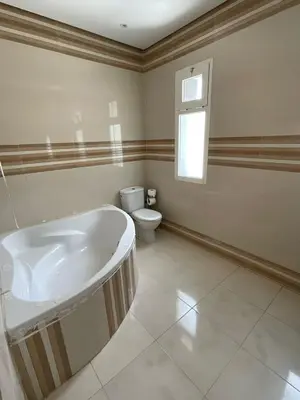 a bathroom with a tub and a toilet at Villa Prestige avec piscine in Tamaris