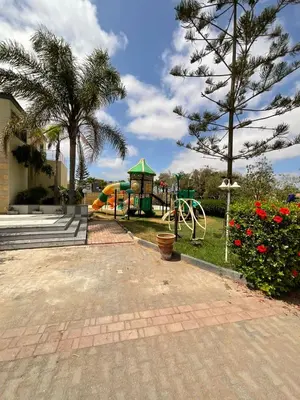 a park with a playground with a slide at Villa Prestige avec piscine in Tamaris