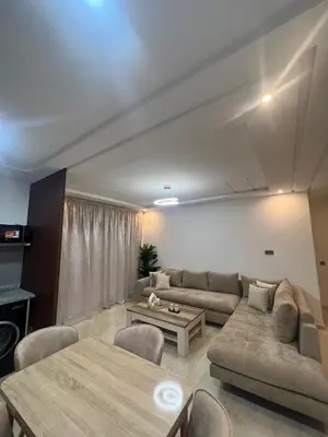 a living room with a couch and a table at Modern fully-equipped apartment in a residence in Pont Blondin