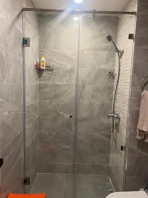a shower with a glass door in a bathroom at Modern fully-equipped apartment in a residence in Pont Blondin