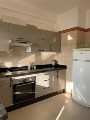 a kitchen with stainless steel appliances and a refrigerator at Beautiful 3 Bedroom in Heart of Hay Riad in Rabat