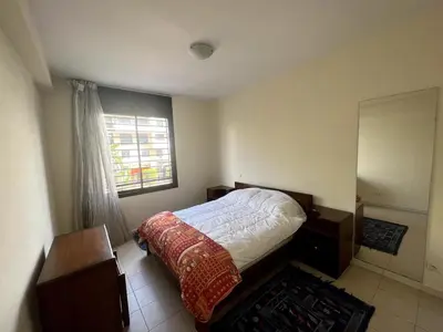 a bedroom with a bed and a window at Beautiful 3 Bedroom in Heart of Hay Riad in Rabat