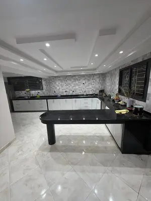 a large kitchen with a black table in a room at Saad's villa in Mohammedia