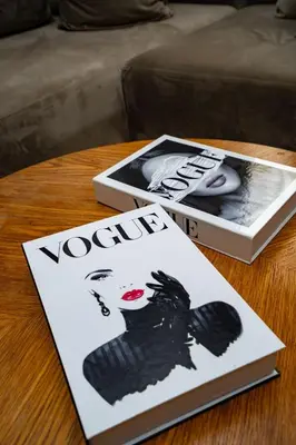a book and a magazine on a table at Appartement cosy & chic Triangle d'or in Casablanca