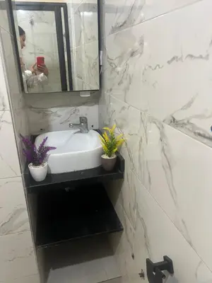 a bathroom with a sink and a mirror at Appartement in Mohammedia