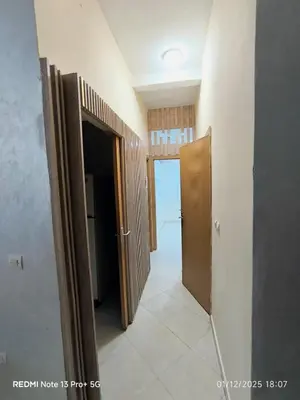 a hallway with two open doors in a room at Appartement in Mohammedia