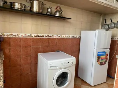 a kitchen with a washing machine and a refrigerator at pretty apparently in Casablanca