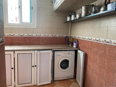 a laundry room with a washing machine in it at pretty apparently in Casablanca