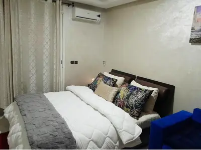 a bedroom with a bed and a couch in it at Studio confortable au centre rabat agdal à côté du stade in Gare de Rabat-Aguedal