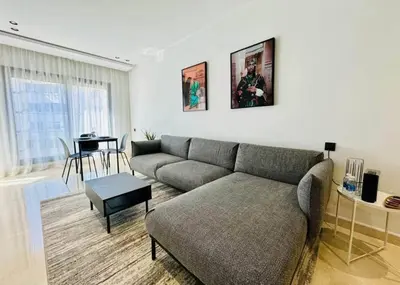 a living room with a couch and a table at Apparemment errahma vile in Casablanca