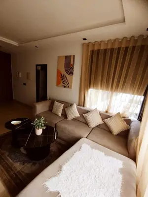 a living room with a couch and a table at New Cozy Studio In the Cornish of Casablanca in Casablanca