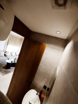a bathroom with a toilet and a wooden door at New Cozy Studio In the Cornish of Casablanca in Casablanca