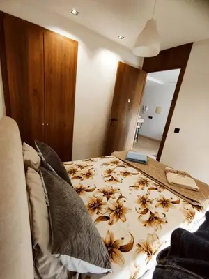 a bedroom with a bed with a comforter with flowers on it at New Cozy Studio In the Cornish of Casablanca in Casablanca