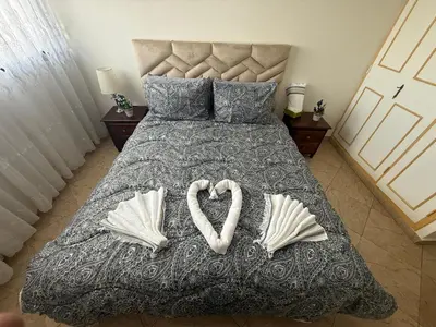 a bed with two hearts shaped pillows on it at Appartement à 2 min gare Agdal bien situé in Rabat