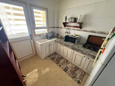 a small kitchen with a sink and a microwave at Appartement à 2 min gare Agdal bien situé in Rabat