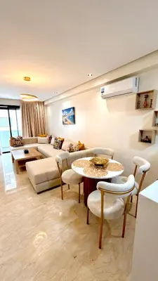 a living room with a couch and a table and chairs at Cozy & Well-Equiped Studio - Valfleuri in Casablanca
