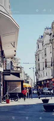 a group of people walking down a city street at Casablanca City Center Neoclassic Flat in Casablanca